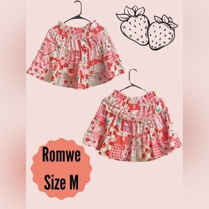 A cute skirt covered in pink strawberries.